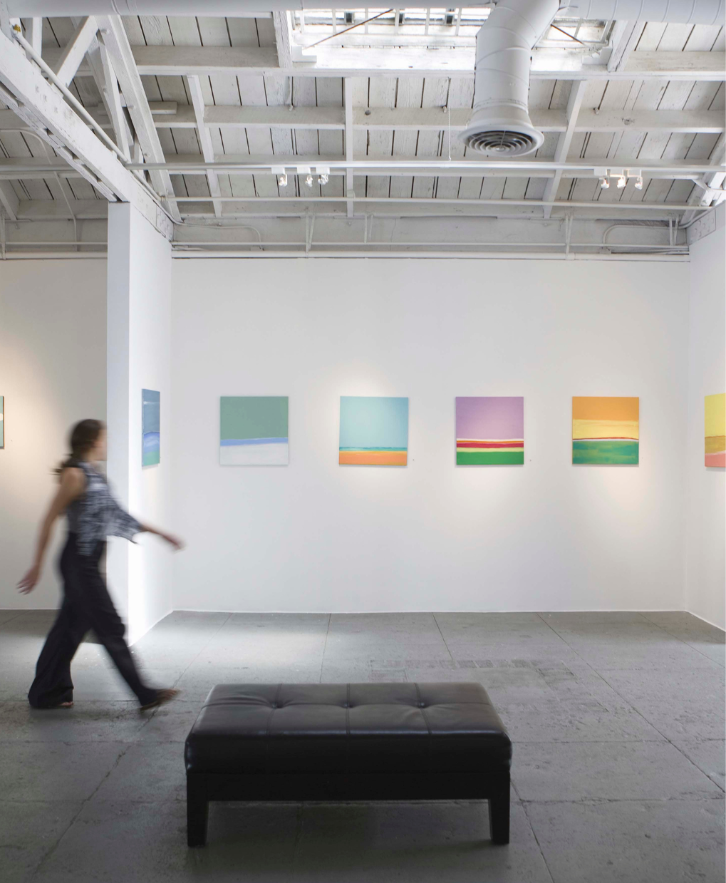 A member enjoying exclusive access to a modern art exhibition, reflecting the sophisticated lifestyle of the La Maison community.